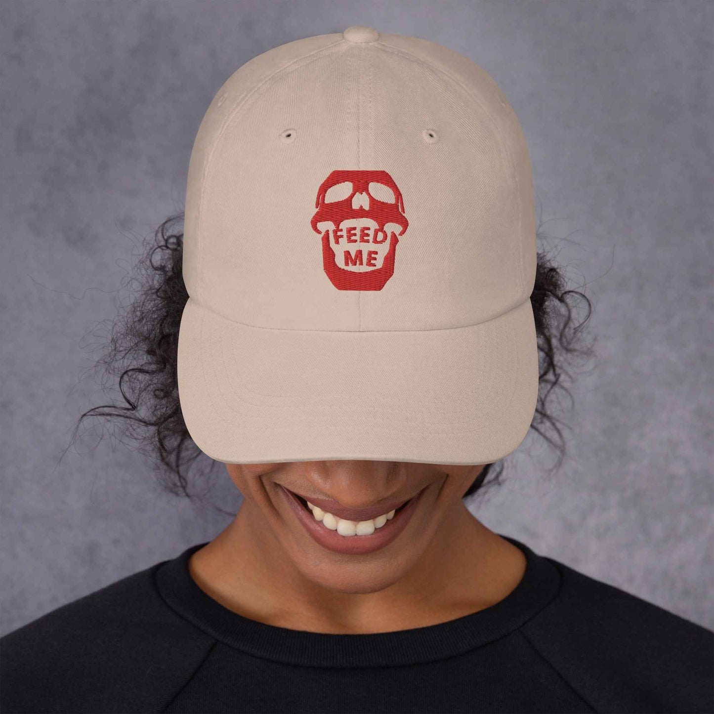 Appetite Apparel's Feed Me Skull dad hat features a playful skull and food-themed embroidery on a casual cotton cap.