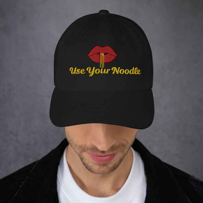 Dark grey Use Your Noodle Dad Hat by Appetite Apparel featuring a Noggin or Knob design, casual and comfortable for everyday wear.