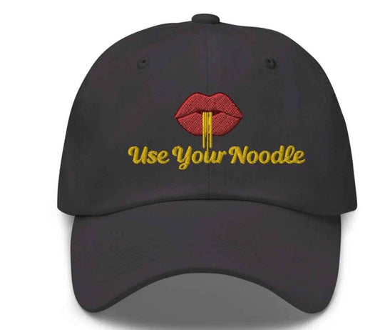 Dark grey Use Your Noodle Dad Hat by Appetite Apparel featuring a Noggin or Knob combo design.