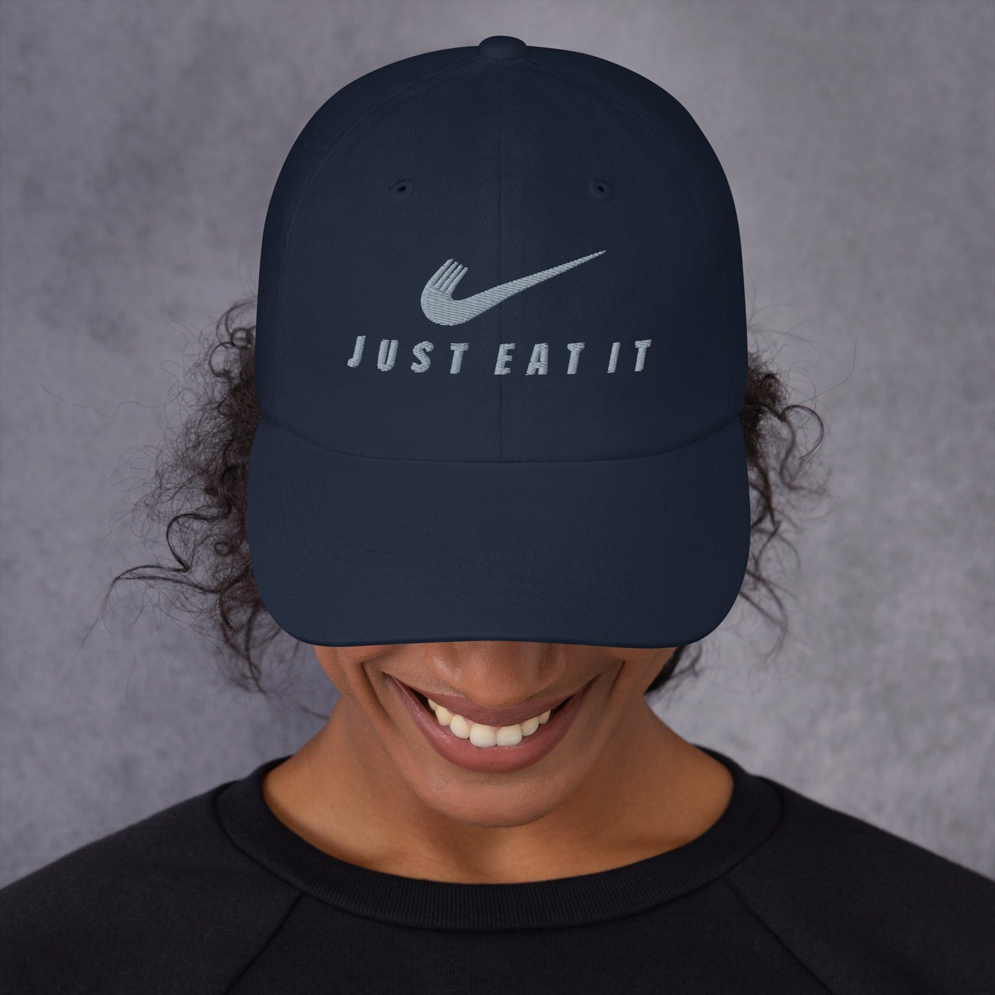Navy classic dad hat with "Just Eat It" Nike parody logo embroidered on front, casual unisex baseball cap by Appetite Apparel